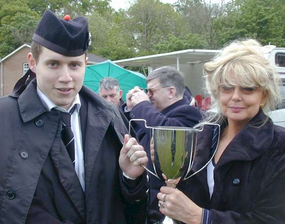 Paul lifting the cup for the best Bass Section in Enniskillen